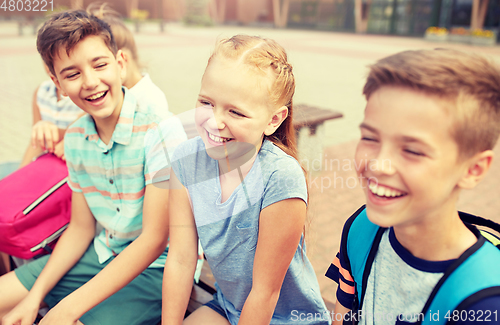 Image of group of happy elementary school students talking