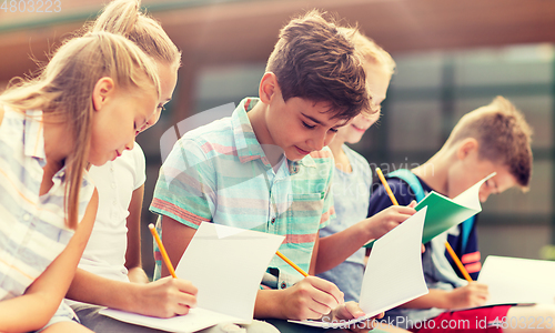 Image of group of happy elementary school students outdoors