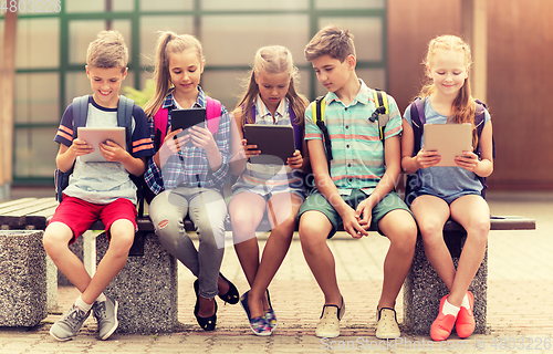 Image of group of happy elementary school students talking