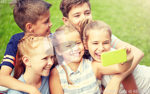 Image of happy kids or friends taking selfie in summer park