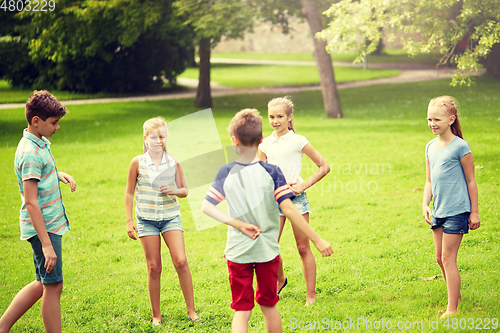 Image of happy kids playing game in summer park