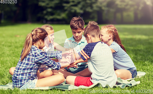 Image of group of happy kids putting hands together