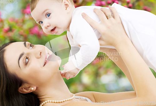 Image of mother with baby over spring garden background