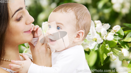 Image of mother with baby over spring garden background