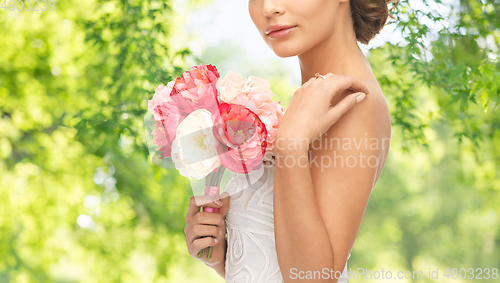 Image of young woman or bride with bouquet of flowers