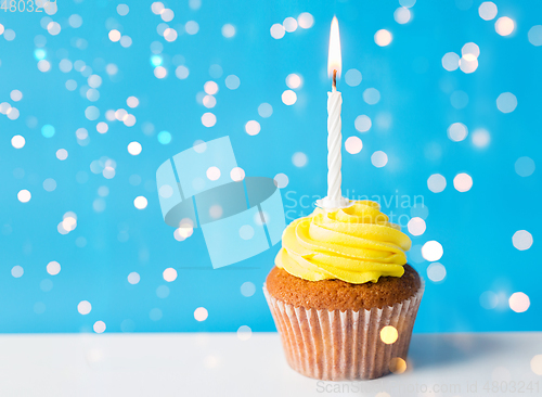 Image of birthday cupcake with one burning candle