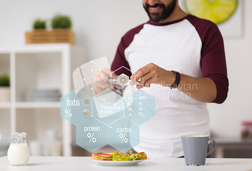 Image of man with phone and food nutritional value chart