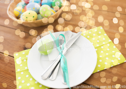 Image of close up of table setting and easter eggs