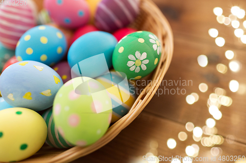 Image of close up of colored easter eggs in basket