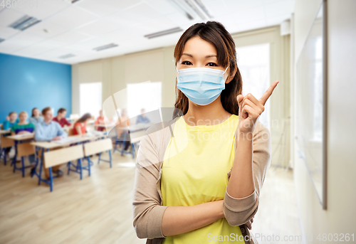 Image of asian young woman in protective medical mask