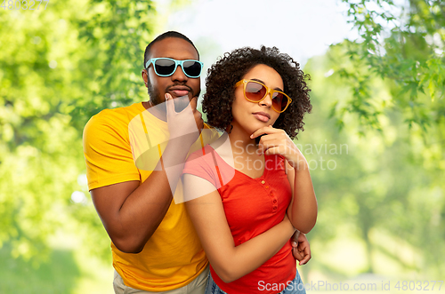 Image of african couple in sunglasses thinking