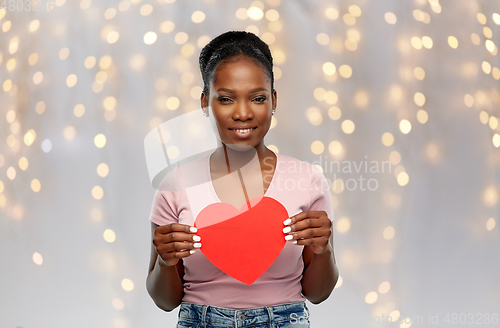 Image of happy african american woman with red heart