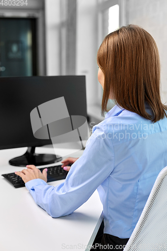 Image of businesswoman with computer working at office