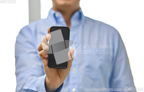 Image of businessman showing smartphone screen