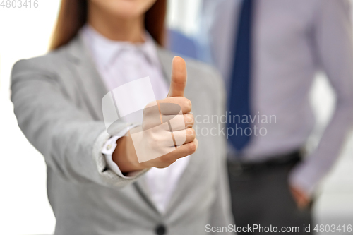 Image of close up of businesswoman showing thumbs up