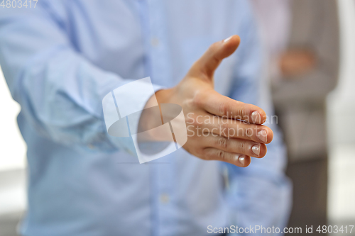 Image of businessman making handshake at office