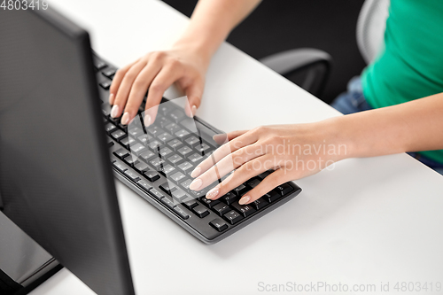 Image of female hands typing on computer keyboard