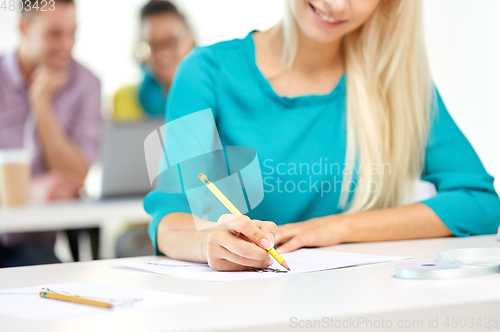 Image of female fashion designer drawing sketch with pencil