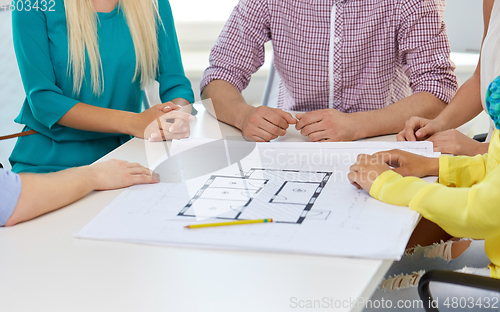 Image of close up of architects team working with blueprint