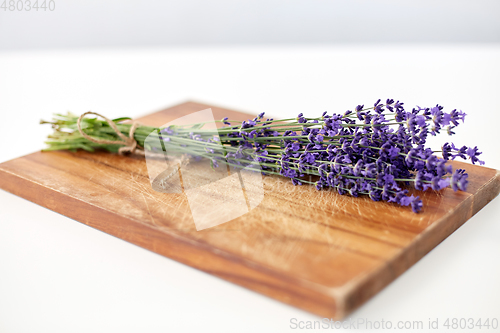 Image of bunch of lavender flowers on wooden board