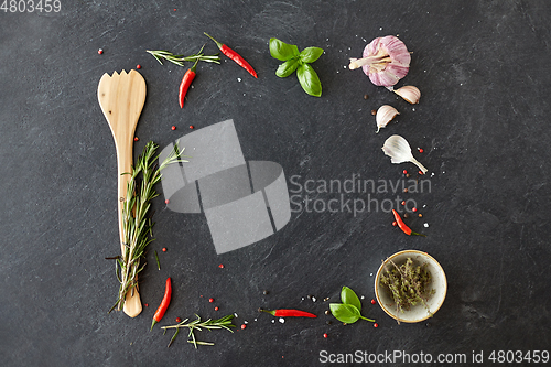 Image of rosemary, garlic and chili pepper on stone surface