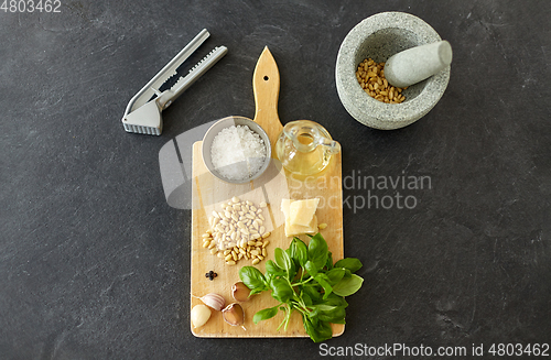 Image of ingredients for basil pesto sauce on wooden board