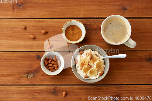 Image of oatmeal with banana and almond on wooden table