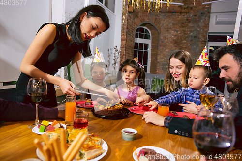 Image of Portrait of happy family celebrating a birthday at home