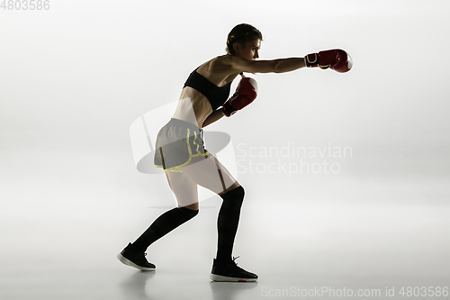 Image of Fit caucasian woman in sportswear boxing isolated on white studio background