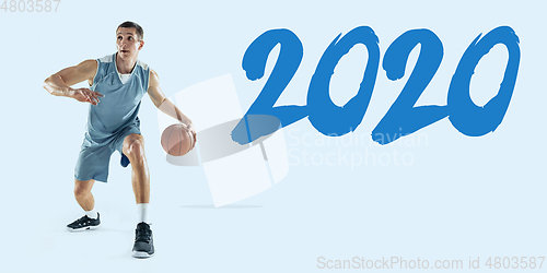 Image of Young caucasian basketball player against white studio background