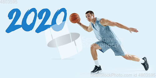 Image of Young caucasian basketball player against white studio background