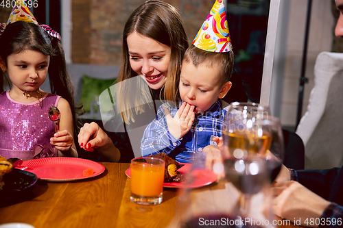 Image of Portrait of happy family celebrating a birthday at home