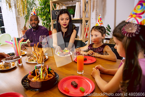 Image of Portrait of happy family celebrating a birthday at home