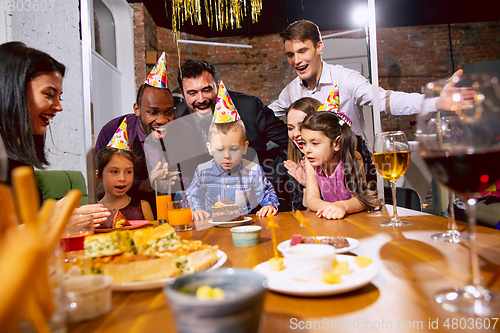 Image of Portrait of happy family celebrating a birthday at home