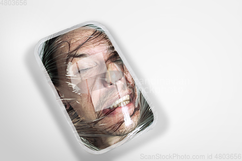 Image of Human head as a goods in plastic box isolated on white background, ecology concept