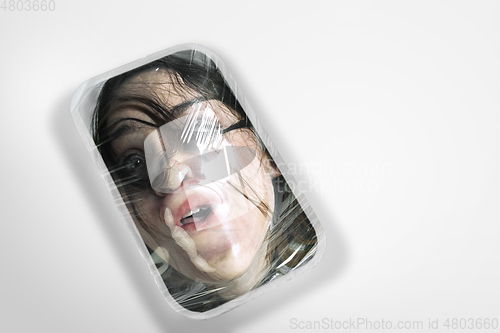 Image of Human head as a goods in plastic box isolated on white background, ecology concept