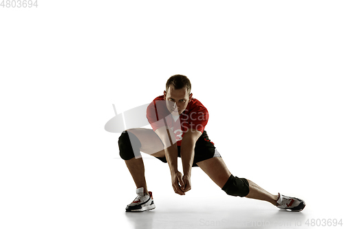 Image of Young caucasian volleyball player placticing isolated on white background