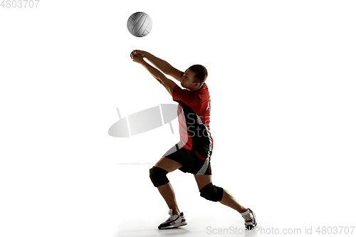 Image of Young caucasian volleyball player placticing isolated on white background