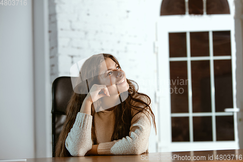 Image of Portrait of young caucasian girl in casual clothes looks dreamful and happy
