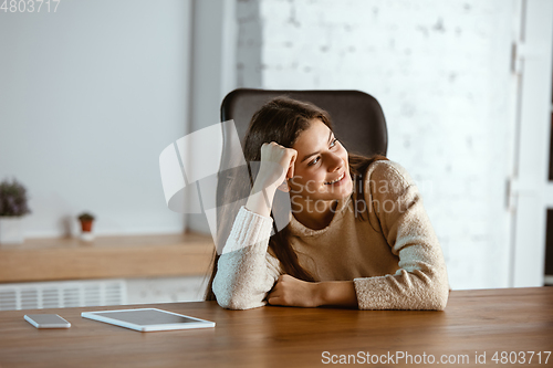 Image of Portrait of young caucasian girl in casual clothes looks dreamful and happy