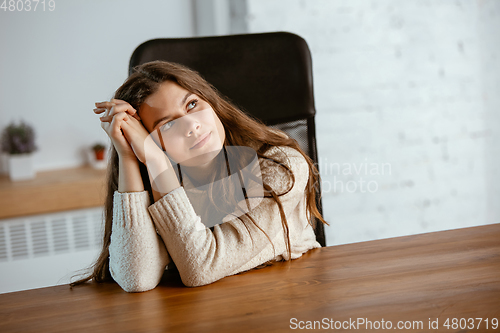 Image of Portrait of young caucasian girl in casual clothes looks dreamful and happy