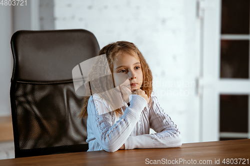 Image of Portrait of young caucasian girl in casual clothes looks dreamful and happy