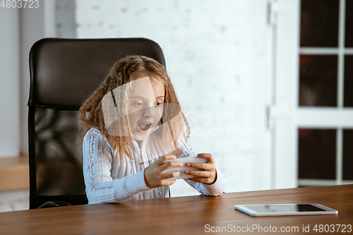 Image of Portrait of young caucasian girl in casual clothes looks dreamful and happy