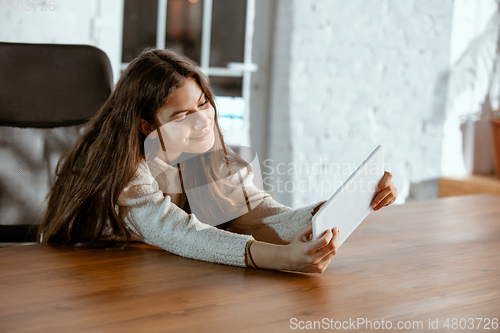 Image of Portrait of young caucasian girl in casual clothes looks dreamful and happy