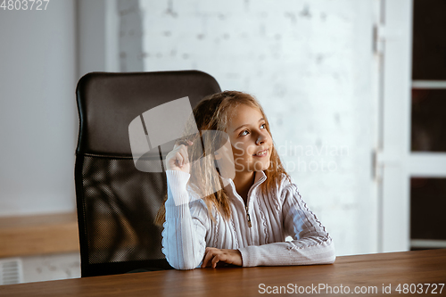 Image of Portrait of young caucasian girl in casual clothes looks dreamful and happy