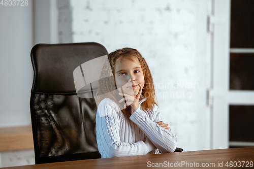 Image of Portrait of young caucasian girl in casual clothes looks dreamful and happy