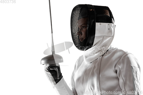 Image of Teen girl in fencing costume with sword in hand isolated on white background