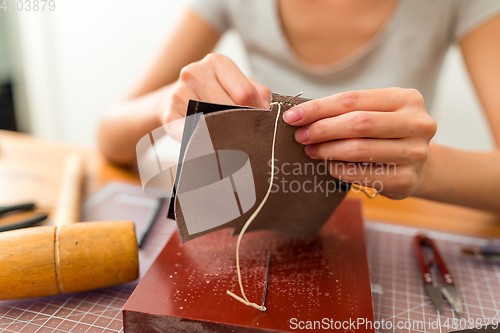 Image of Woman making leather