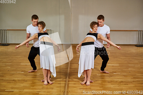 Image of beautiful couple dancing tango