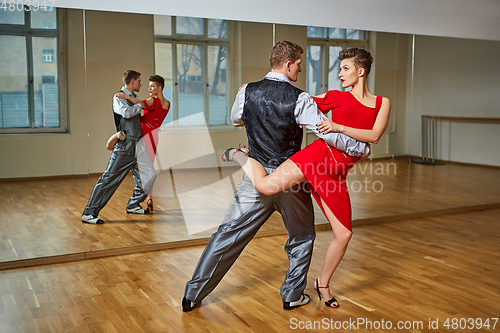 Image of beautiful couple dancing tango